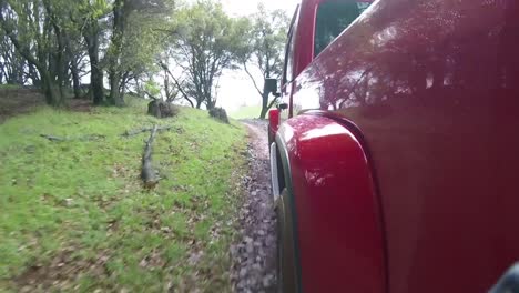 red truck driving down rocky road
