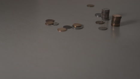 pennies and dime stacks being picked up