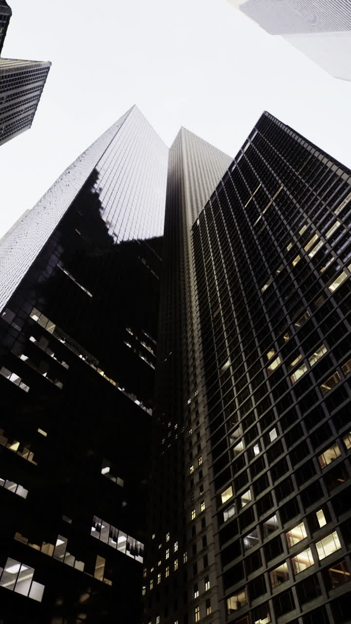 Urban skyscrapers create a dramatic perspective in a bustling city skyline