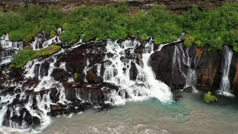 hraunfossar waterfalls cascading to hvita from ledges of moss covered rocks in west iceland