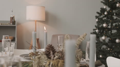 woman blowing out candle on festive table