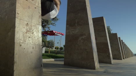 joven haciendo un truco de tumble en la ciudad