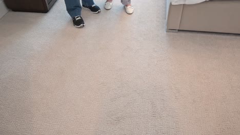 couple standing in their bedroom give the thumbs-up sign and smile