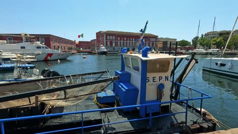 fishing boat and yachts in a sunny harbor