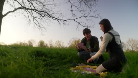friends playing cards in a park