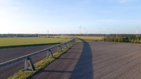 flyover elevated maglev transrapid test track with wind power turbines at background in emsland, germany