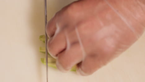 chef chopping fresh avocado for sushi - overhead shot