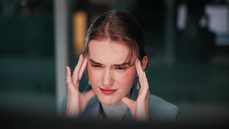Businesswoman with headache in office