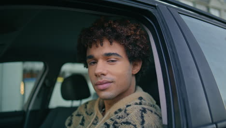 handsome hipster smiling car looking camera closeup. guy sitting automobile