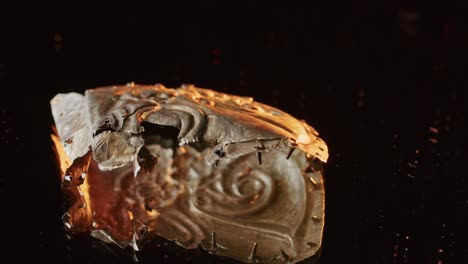 a gold brooch of a scythian priestess 2000 years old, an old earring, a spinning wheel, found during excavations. vintage jewelry. religion. close-up