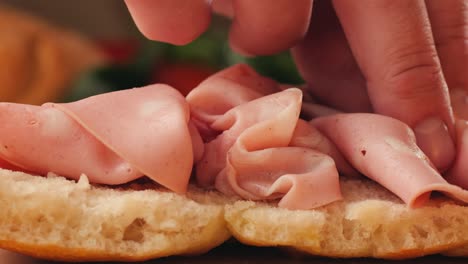 making a sandwich with prosciutto and ciabatta