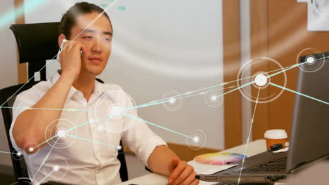 animation of network of connections with icons over asian businessman in office