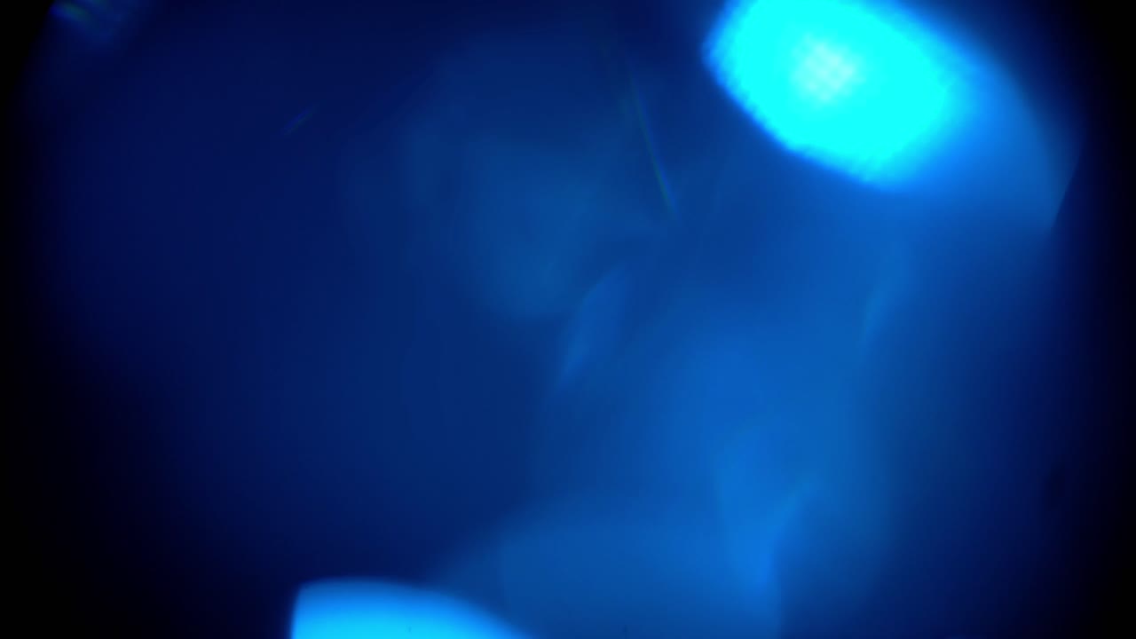 Perdite di luce blu astratte e bagliori dell'obiettivo su sfondo nero