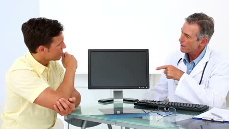 patient explaining elbow pain to his doctor