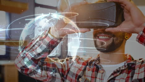 smiling man using vr headset with digital globe and network connections over