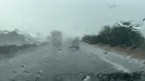 driving during a storm of rain and hail, driver point of view