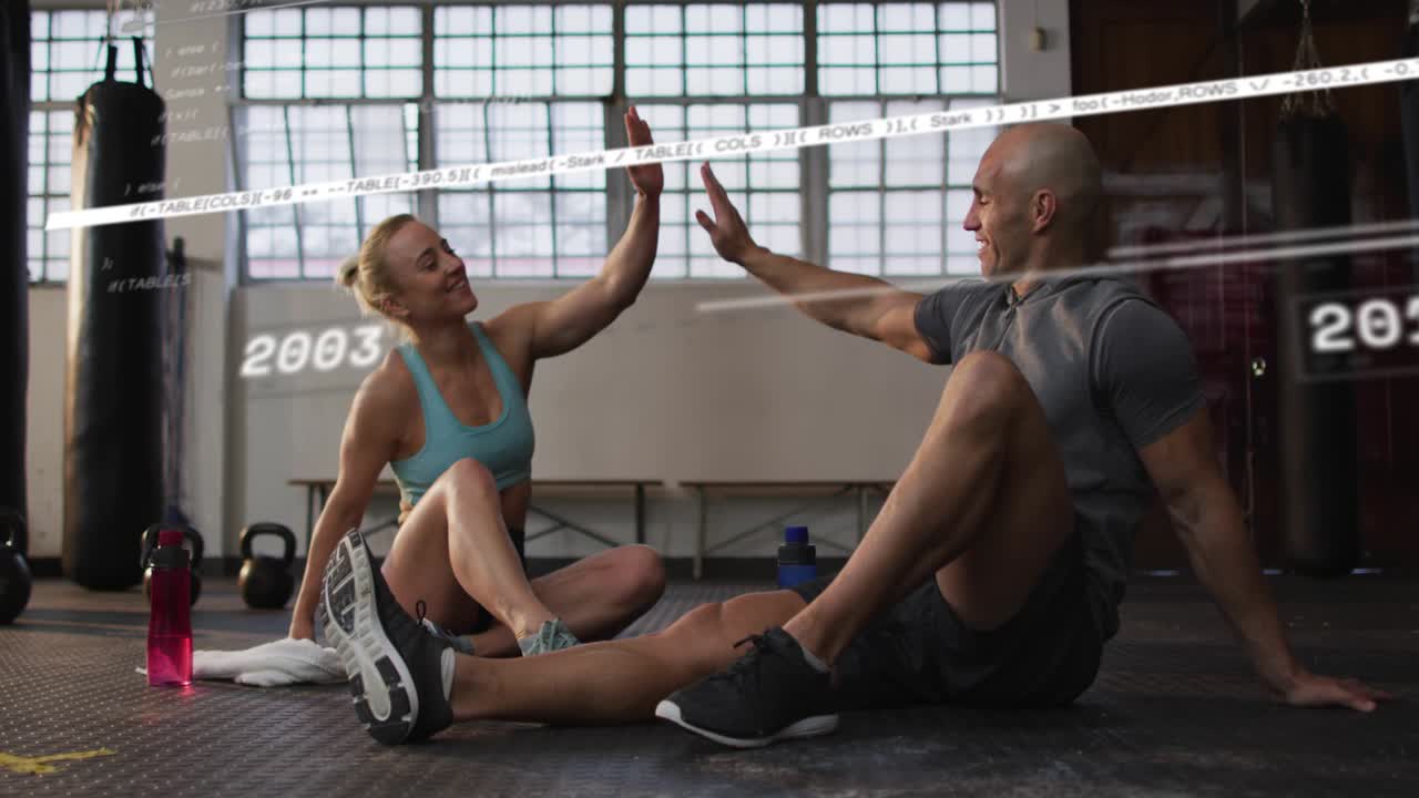 Training pair sitting on gym mat timeline scrolling showing fitness gains and sparking high-five