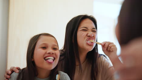 Mom,-child-and-brushing-teeth-in-mirror