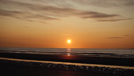 Man-running-with-guitar-in-back-sand-beach-at-sunset-27