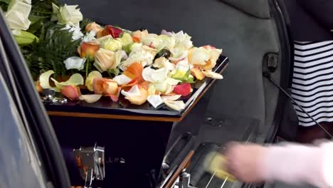 closeup shot of a funeral casket in a hearse or chapel or burial at cemetery