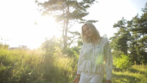 a young woman joyfully enjoys the golden hour light in a peaceful outdoor setting, radiating beauty and happiness