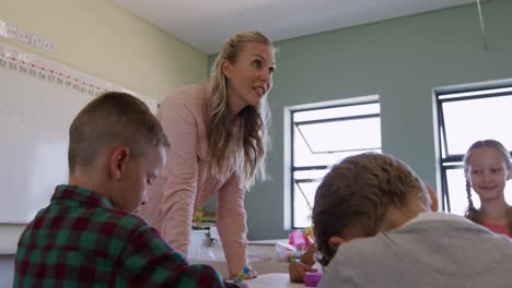 female teacher teaching kids in the class