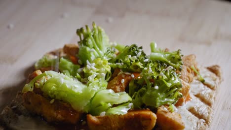 Sprinkling-Sesame-Seeds-On-Anabolic-Toast-Sandwich-With-Chicken-Breast-And-Steamed-Broccoli,-Dressed-With-Red-Hot-Sauce