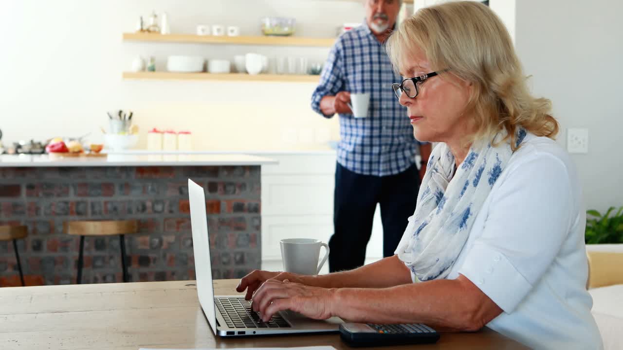 Senior couple using laptop