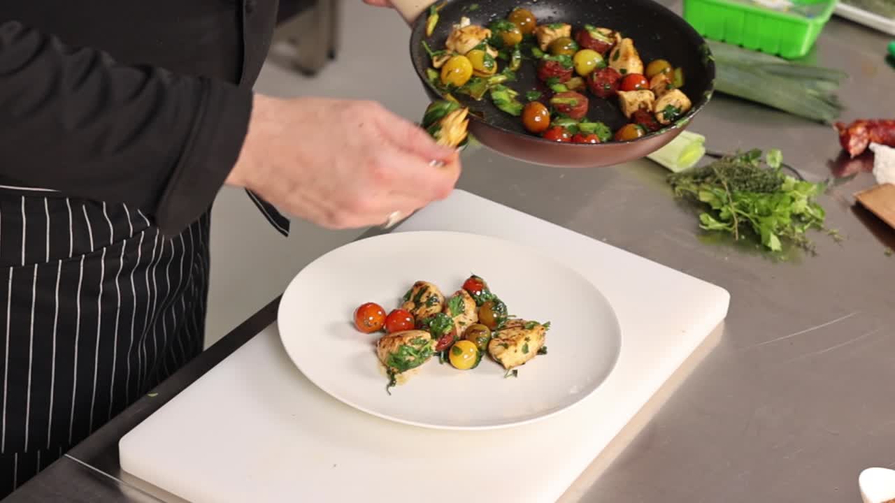 Chef preparing a chicken and tomato dish