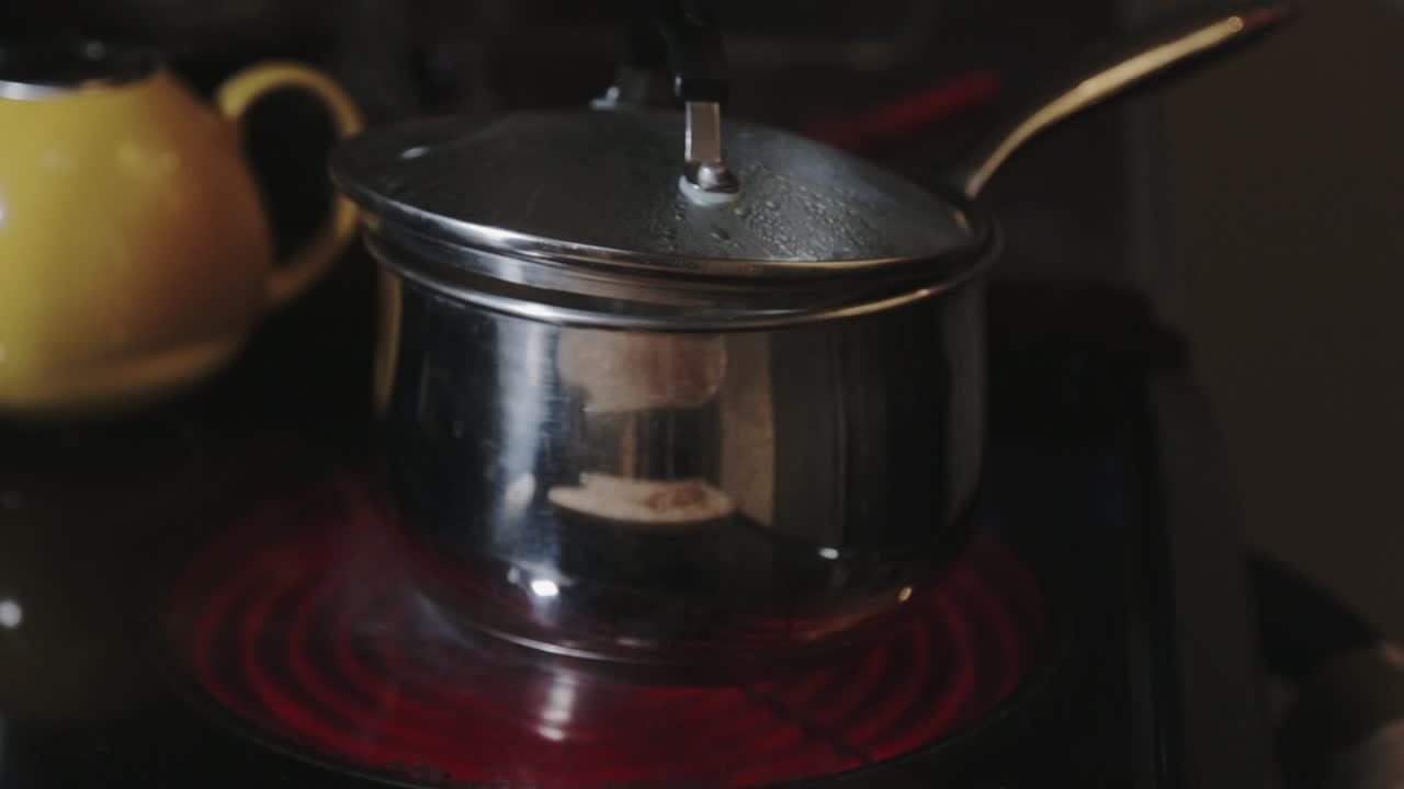 Cooking Pot Lid Slightly Opened With Boiling Water - Close Up Shot