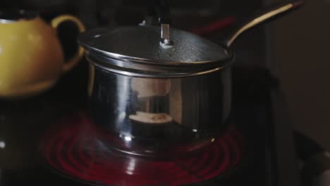 cooking pot lid slightly opened with boiling water - close up shot