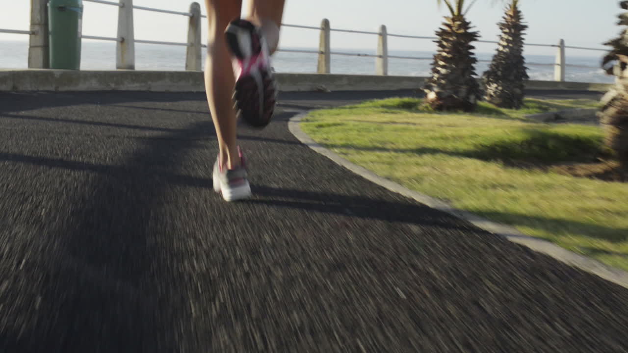 Mixed race woman runner running on road