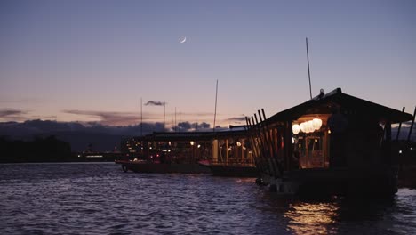 dusk over nagara river, boats ready to view ukai cormorant fishing festival