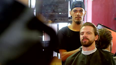 hairdresser showing hair cut in a mirror 4k