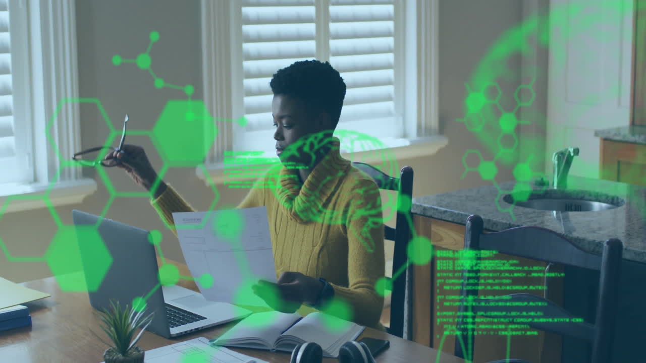 Analyzing documents at desk, person with laptop over scientific data animation