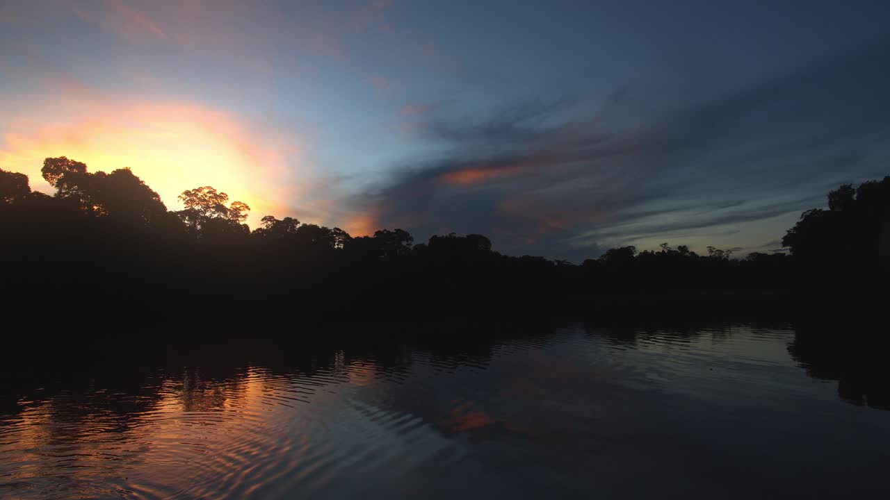 Extremely beautiful Sunset over the oxbow lake with ripples on the water and brilliant colours in the sky