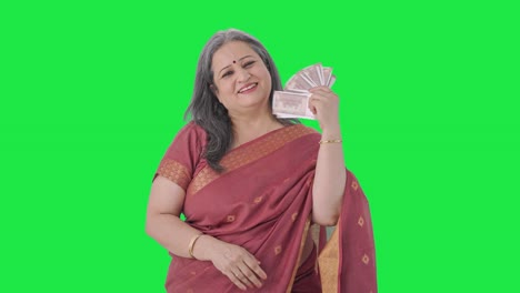 Happy-Indian-old-woman-using-money-as-fan-Green-screen