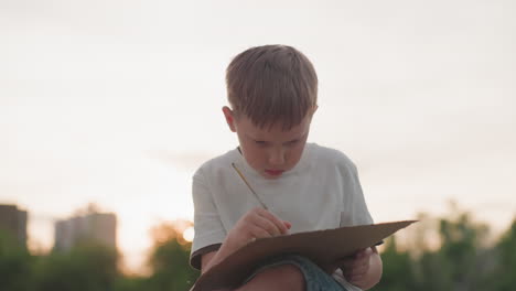youngster sitting on wooden dock under soft sunset sky, deeply concentrating on painting with brush on board, careful strokes highlighting creativity and focus during warm evening art session