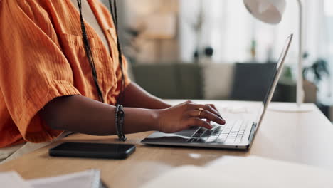 hands of woman at desk, typing