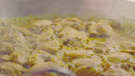 Adding-yellow-rice-on-top-of-cooked-chicken