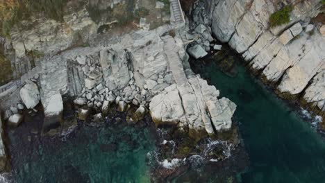 Aerial-view-of-the-city-Kavala-in-Northern-Greece-demonstrating-the-harbour,-the-old-fortress-the-breakwater-and-the-rocky-seasides