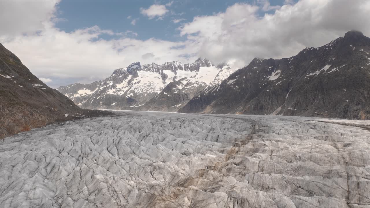 The vast glacier landscape surrounded by towering norwegian mountains, aerial view