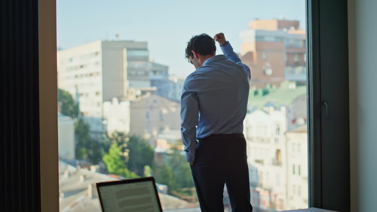Exhausted businessman standing office window. Tired man manager feeling stress