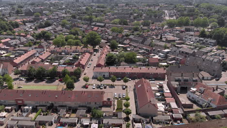 aerial-view-of-drone-flying-over-a-dutch-neighborhood-on-a-summer-day,-loads-of-terraced-houses,-gardens-and-trees