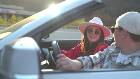 couple enjoying a road trip in a convertible