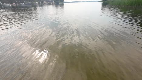 pov shot to feet steping to the lake water