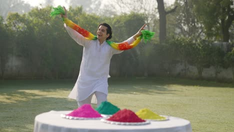 happy indian man dancing at a holi party