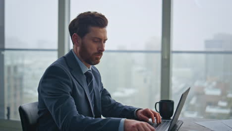 man manager corresponding client using laptop office closeup. guy taking notes