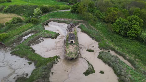 drone aerial view of abandoned wooden boat in