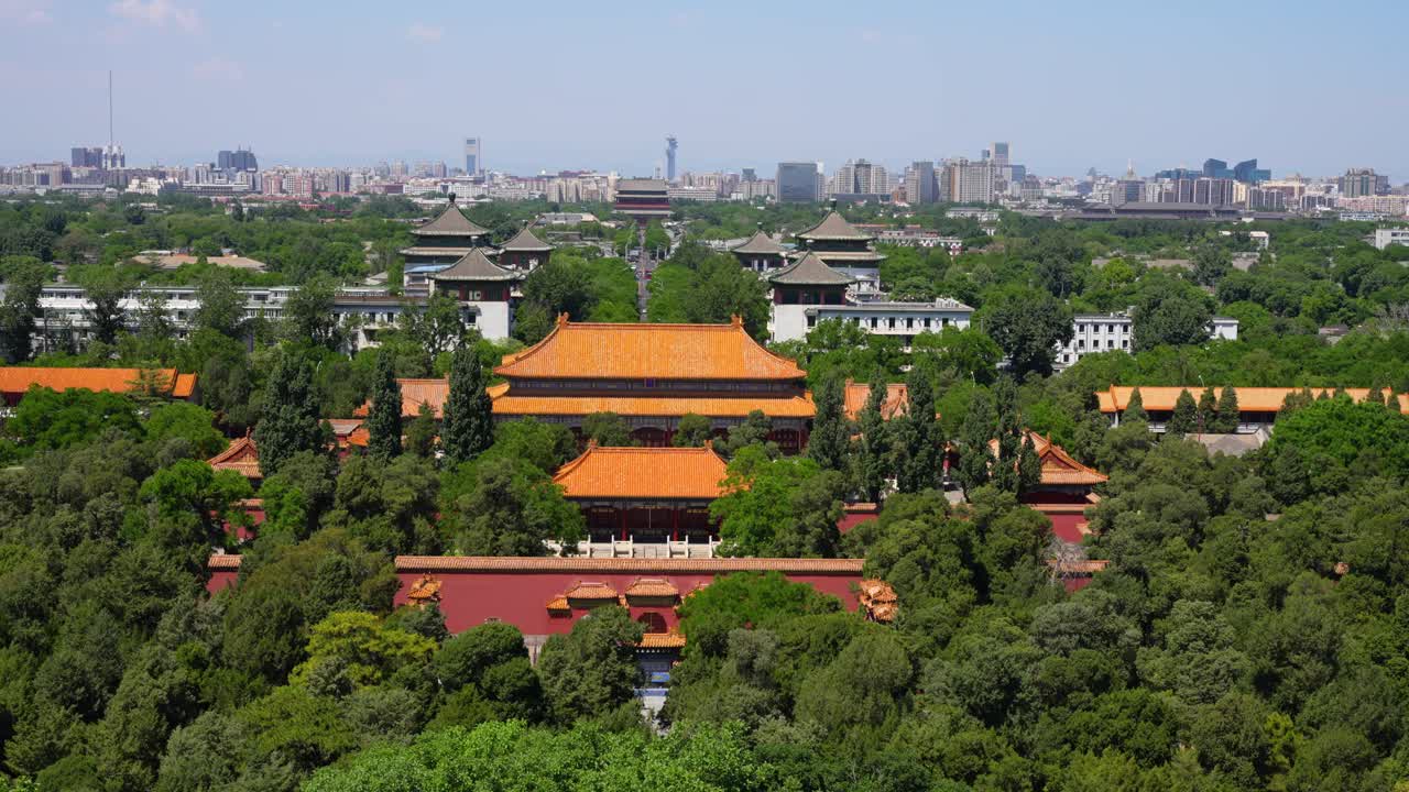 Longevity Palace rooftops and modern Beijing skyline in background viewed from Jingshan Park on a sunny day